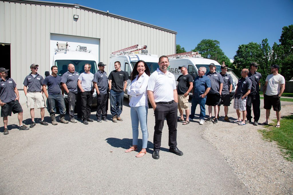 The Select Heating and Cooling team in front of the shop